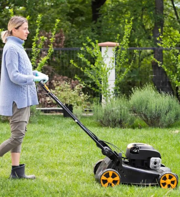 long-shot-woman-mowing-yard